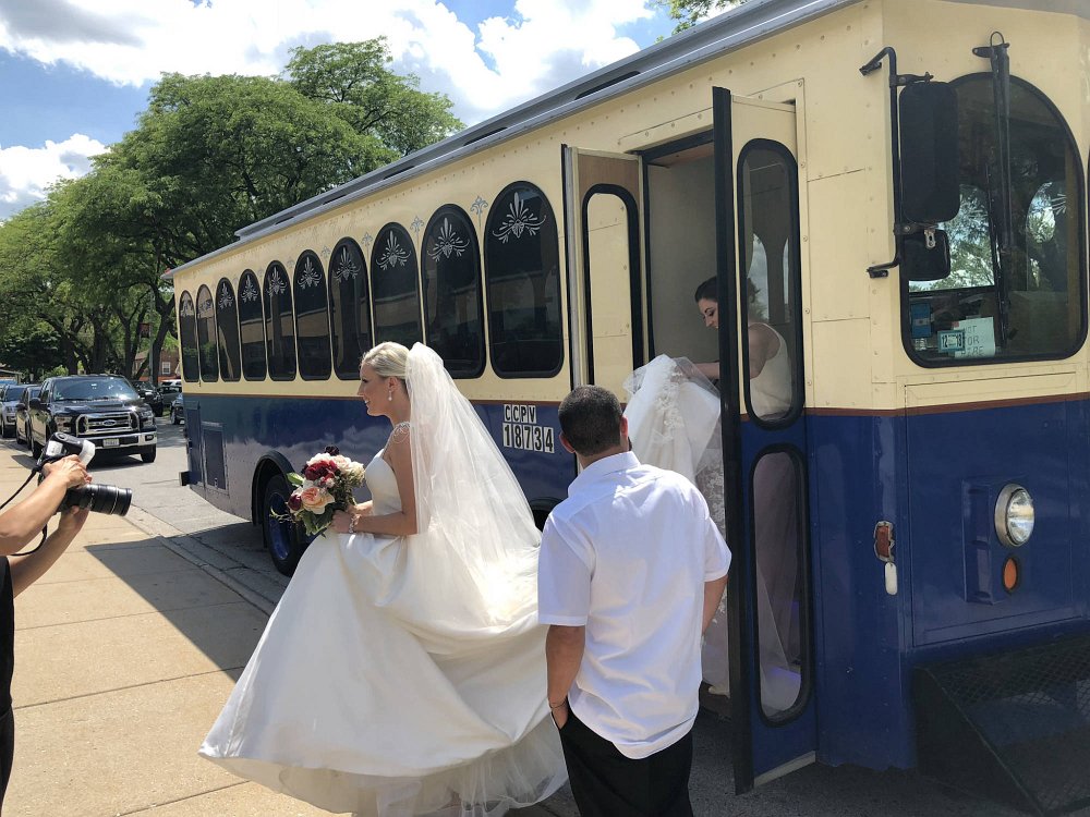 Bride boarding a Chicago wedding trolley party bus